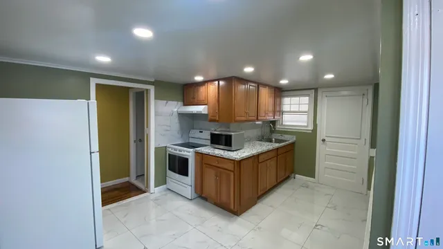 a kitchen with a stove top oven and cabinets