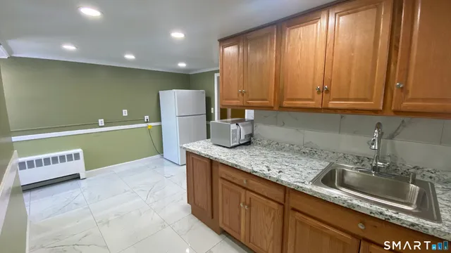 a kitchen with a sink cabinets and window