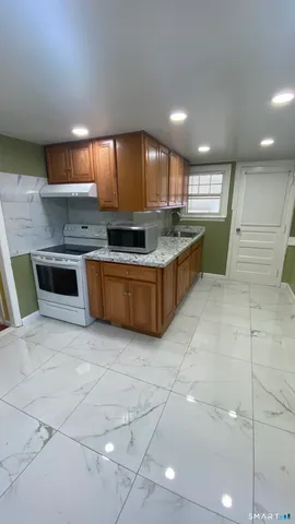 a kitchen with stainless steel appliances granite countertop a sink and cabinets