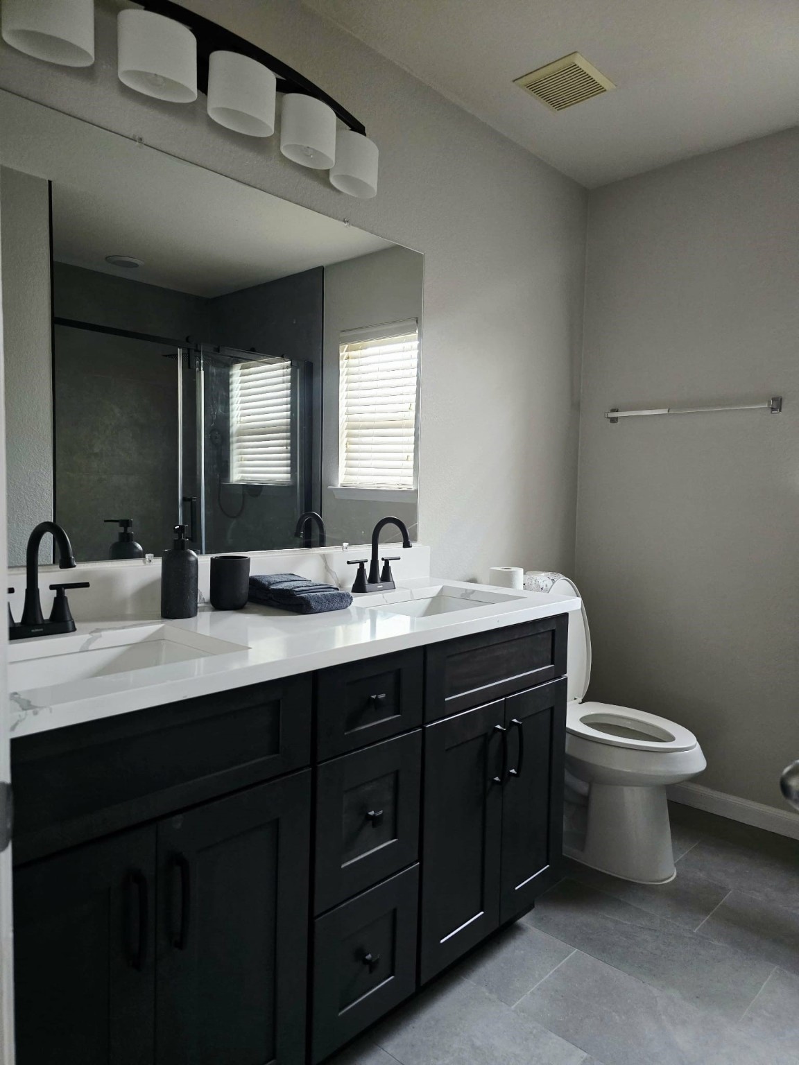 15618 Sweet Maple Court Houston, TX 77049 - Photo 14 of 23 a bathroom with a double vanity sink toilet and a mirror