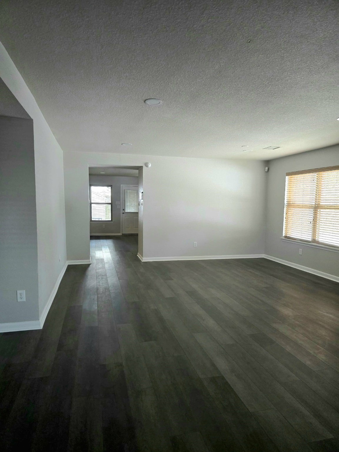 15618 Sweet Maple Court Houston, TX 77049 - Photo 3 of 23 an empty room with wooden floor and windows