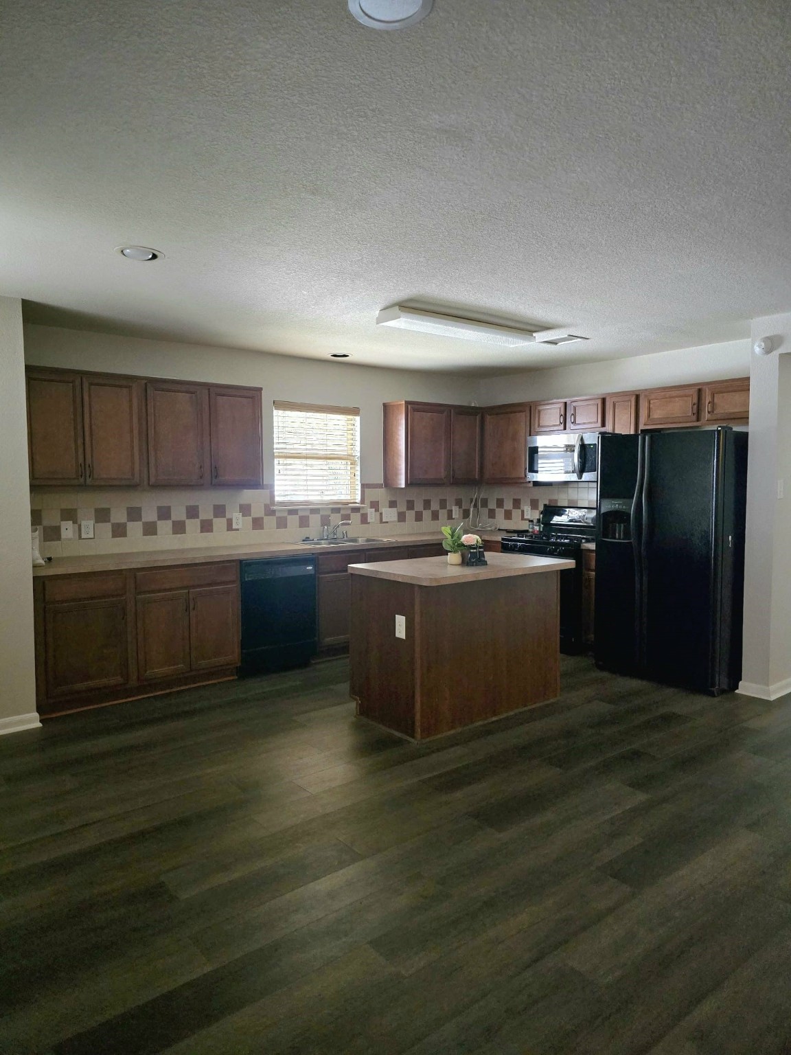 15618 Sweet Maple Court Houston, TX 77049 - Photo 4 of 23 a kitchen with stainless steel appliances kitchen island granite countertop a stove a sink dishwasher a refrigerator and a oven with wooden floor