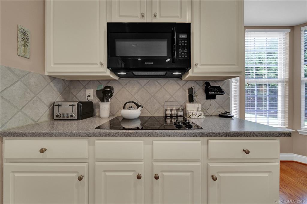 340 Garnet Court Fort Mill, SC 29708 - Photo 11 of 44 a kitchen with white cabinets and a sink