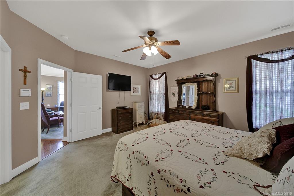 340 Garnet Court Fort Mill, SC 29708 - Photo 19 of 44 a bedroom with a bed and a fireplace