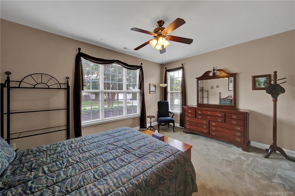 340 Garnet Court Fort Mill, SC 29708 - Photo 27 of 44 a bedroom with a bed and a chandelier