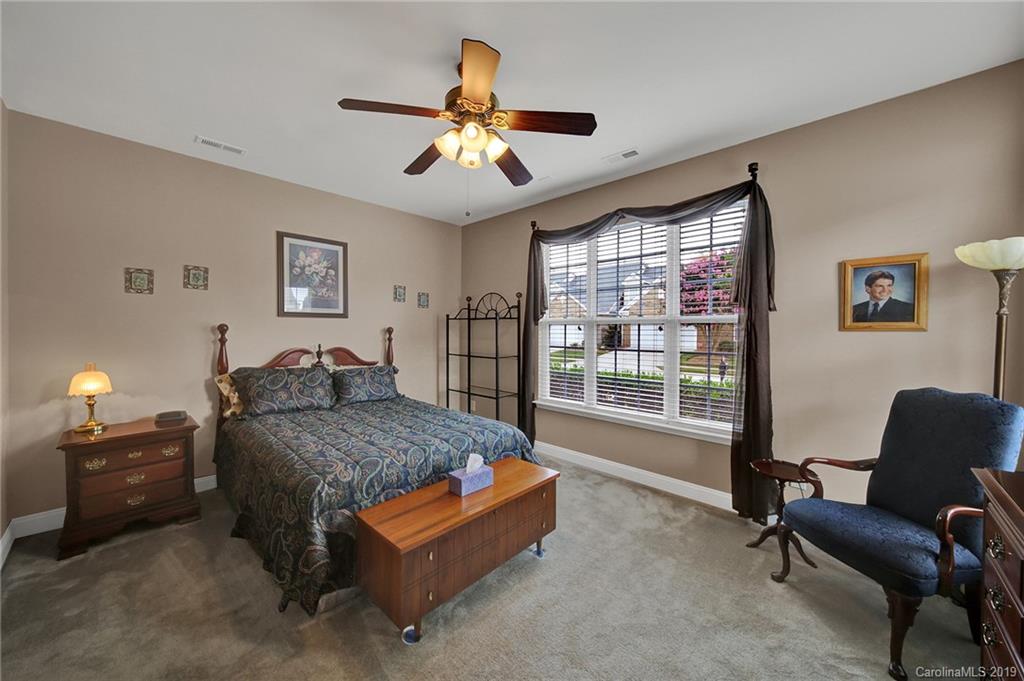 340 Garnet Court Fort Mill, SC 29708 - Photo 28 of 44 a bedroom with a bed and a chandelier