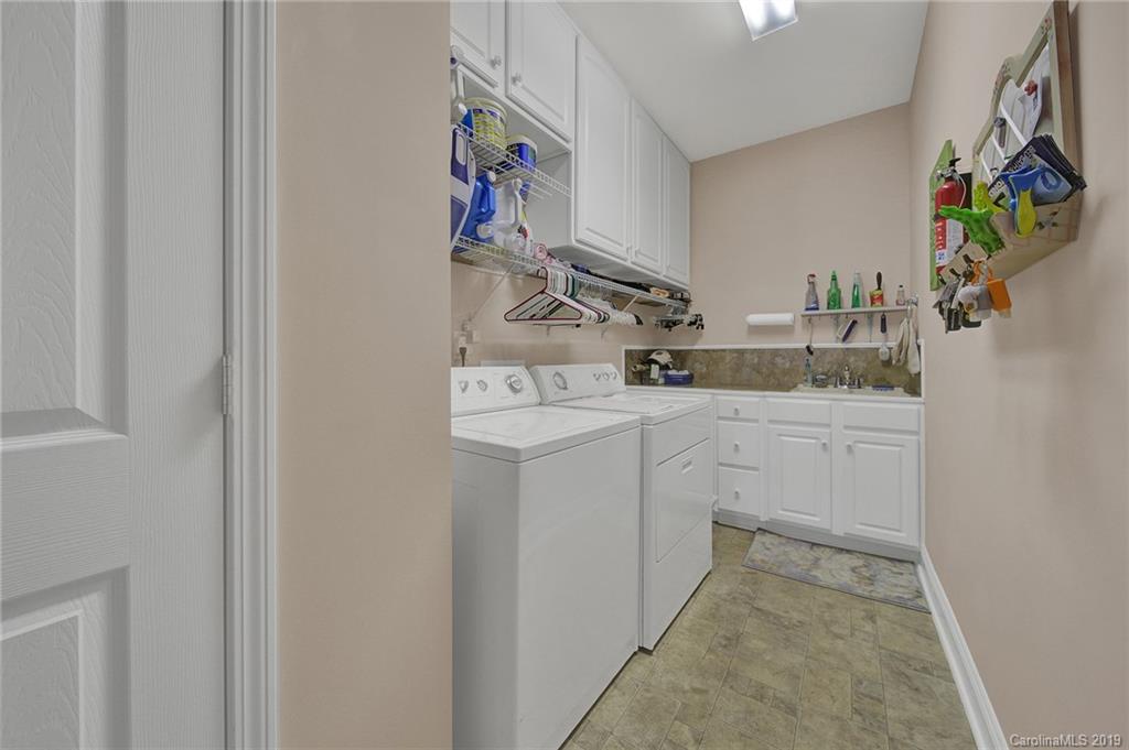 340 Garnet Court Fort Mill, SC 29708 - Photo 31 of 44 a utility room with sink dryer and washer