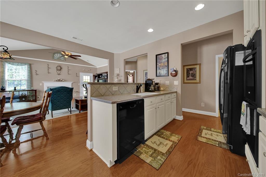 340 Garnet Court Fort Mill, SC 29708 - Photo 8 of 44 a kitchen with a sink cabinets and wooden floor