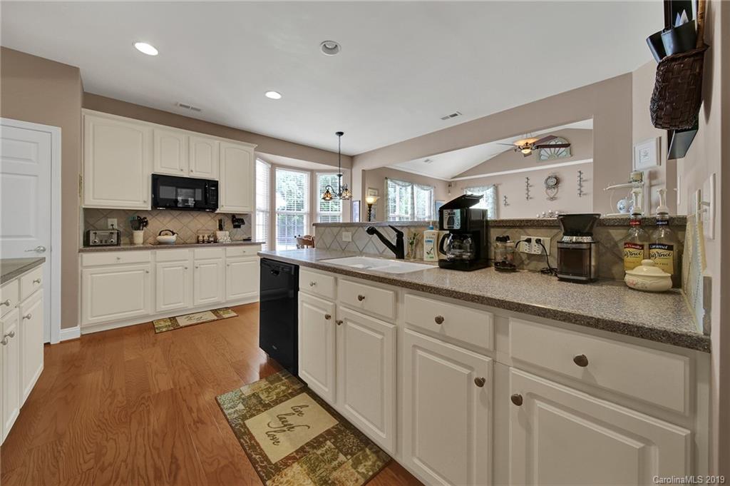 340 Garnet Court Fort Mill, SC 29708 - Photo 9 of 44 a kitchen with stainless steel appliances granite countertop a sink a stove top oven a counter space and cabinets