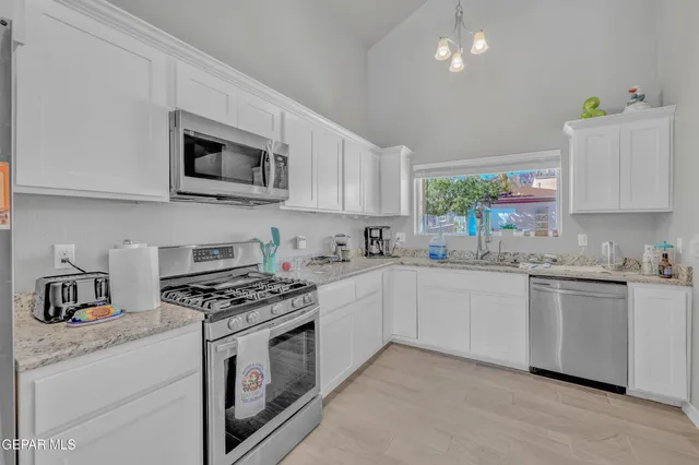 a view of a livingroom with furniture and a kitchen