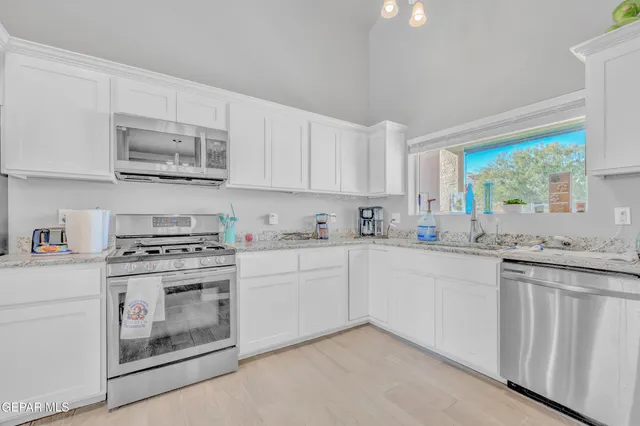 a view of a room with furniture and a chandelier