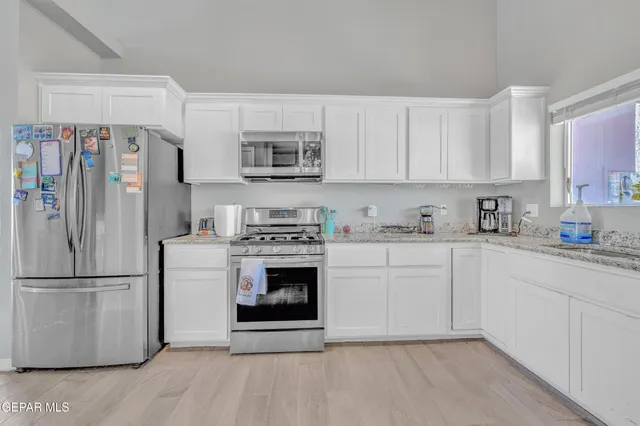 a dining room with furniture a chandelier and wooden floor