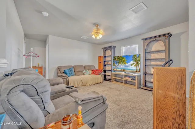 a living room with a couch and a chandelier
