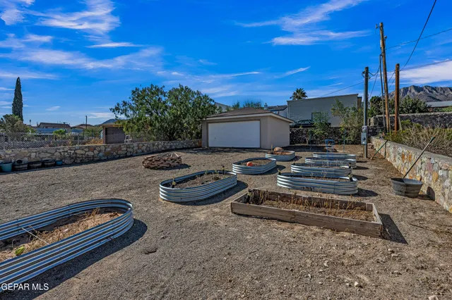 a view of a backyard with furniture and a fire pit