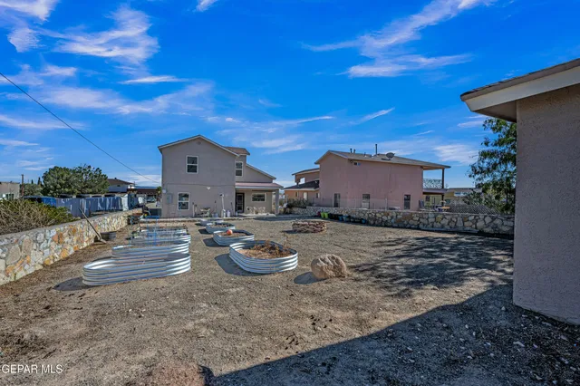 a view of a house with backyard and sitting area