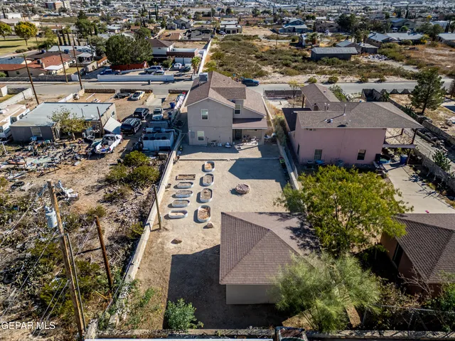 an aerial view of a house with a yard and lake view