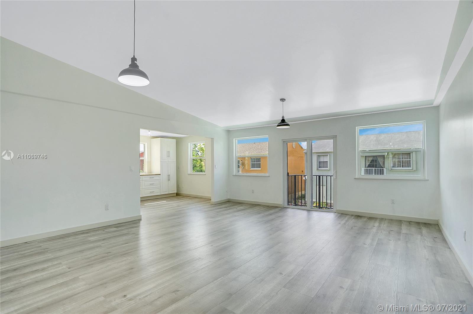 12121 Southwest 271st Street Homestead, FL 33032 - Photo 14 of 20 an empty room with wooden floor and windows