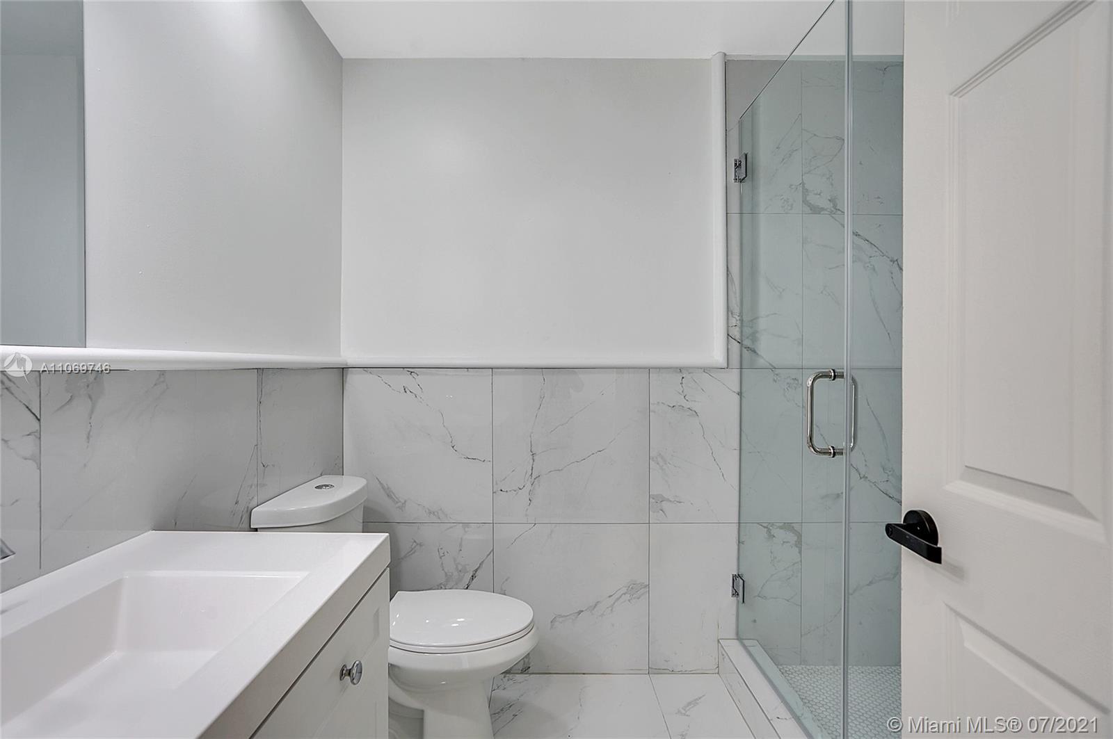 12121 Southwest 271st Street Homestead, FL 33032 - Photo 18 of 20 a bathroom with a sink a toilet and shower