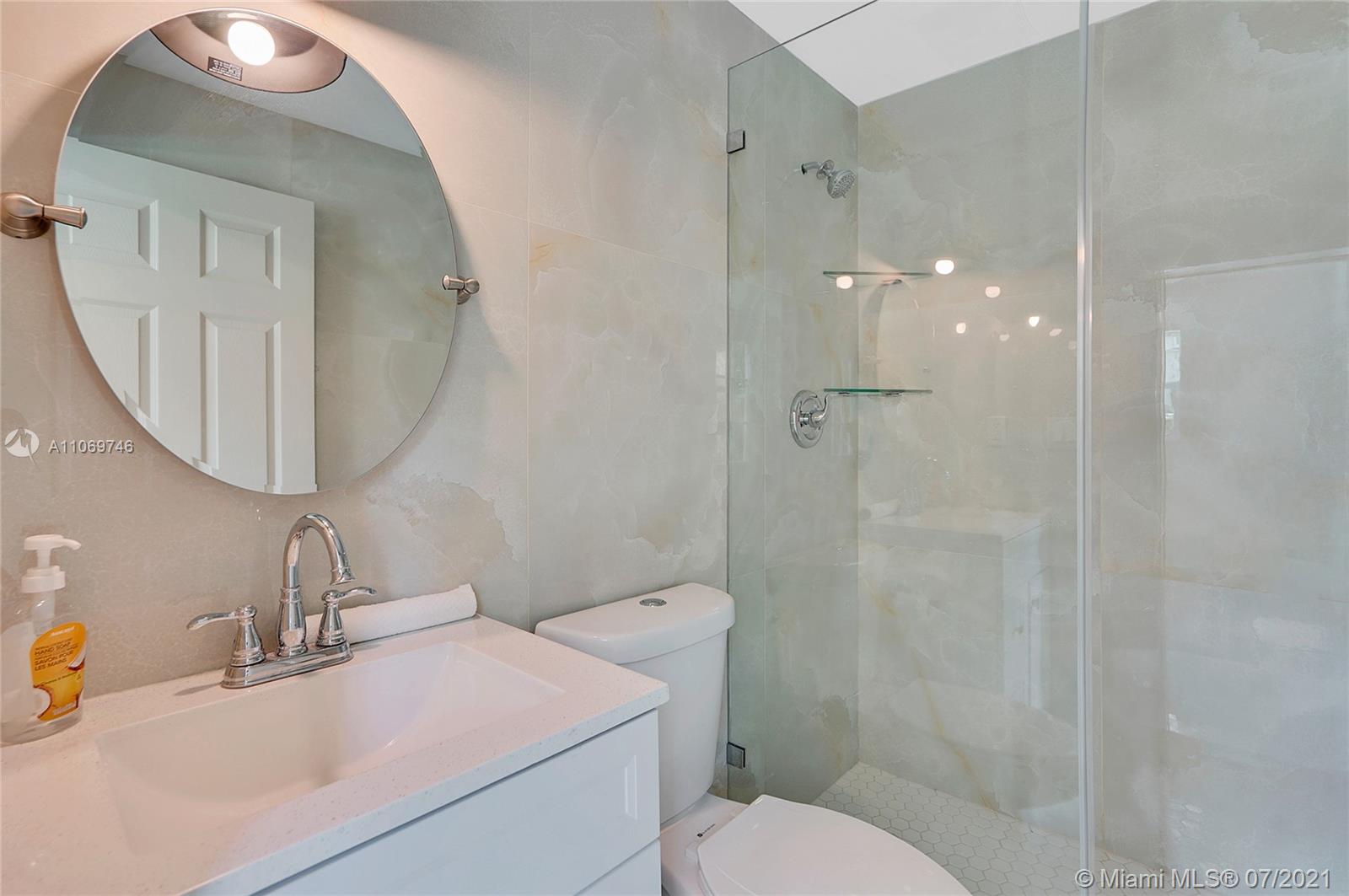 12121 Southwest 271st Street Homestead, FL 33032 - Photo 4 of 20 a bathroom with a sink toilet and shower