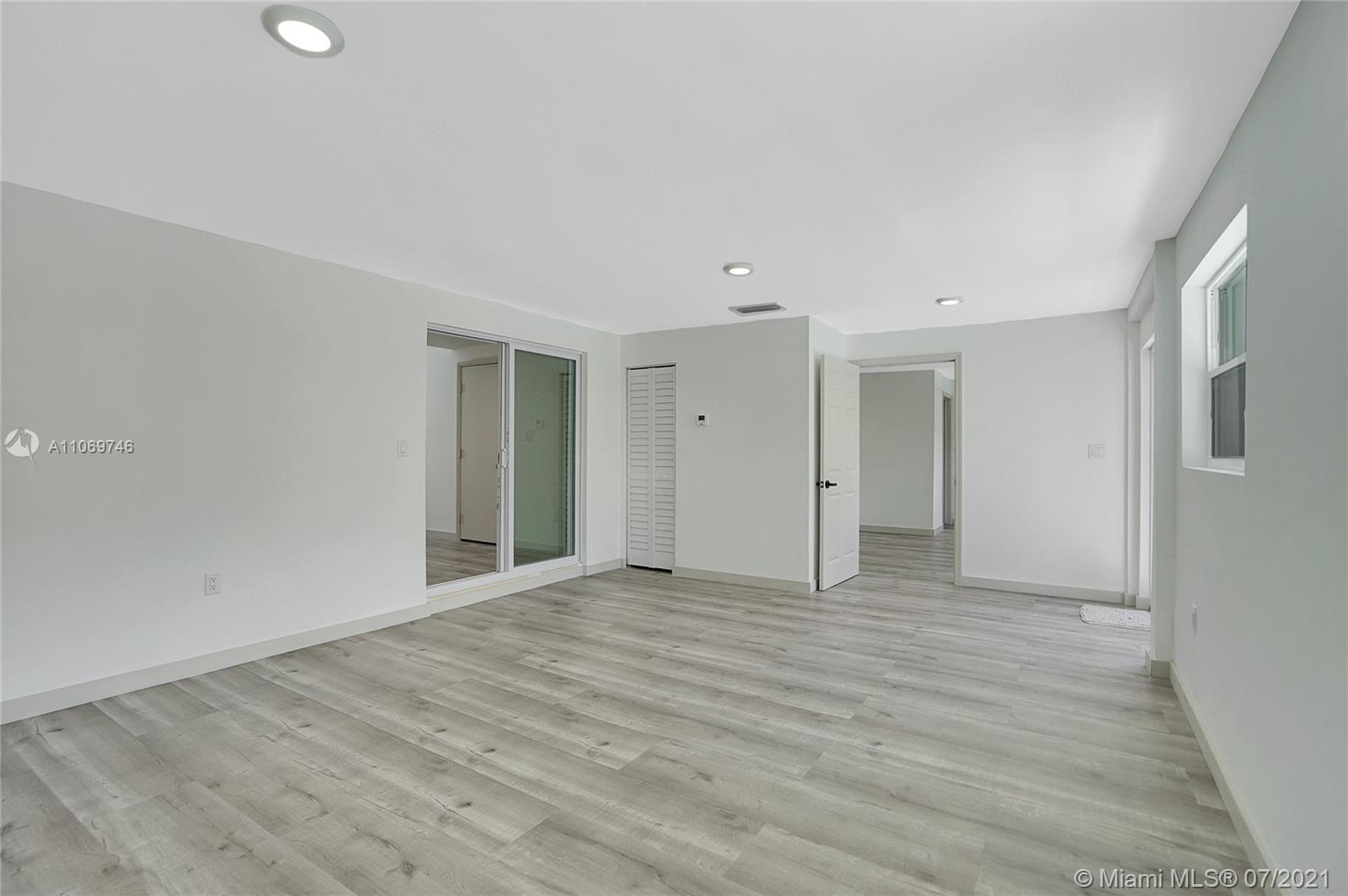 12121 Southwest 271st Street Homestead, FL 33032 - Photo 7 of 20 a view of an empty room with wooden floor