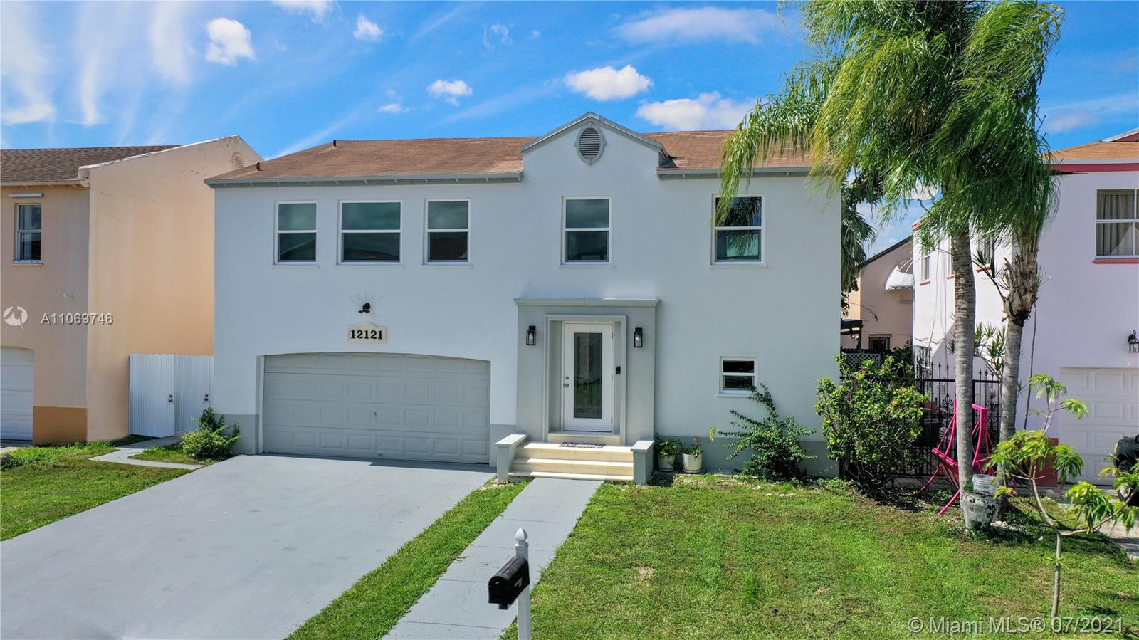 12121 Southwest 271st Street Homestead, FL 33032 - Photo 9 of 20 a front view of a house with a garden and plants