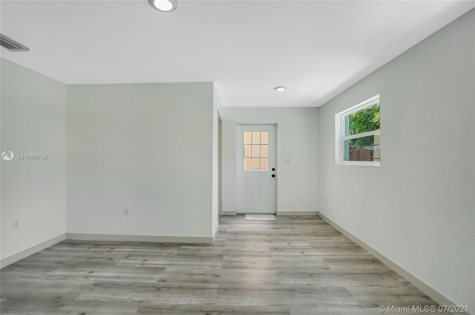 12121 Southwest 271st Street Homestead, FL 33032 - Photo 10 of 20 a view of an empty room with wooden floor and a window