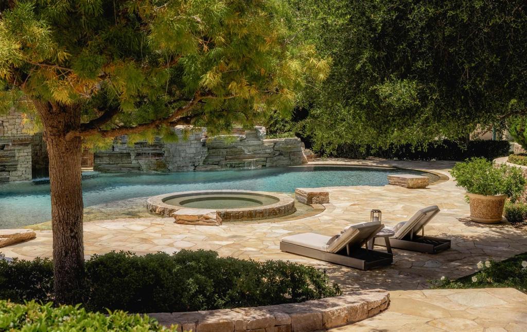 6853 Rancho Valencia Road Rancho Santa Fe, CA 92067 - Photo 16 of 29 a view of a swimming pool with a patio