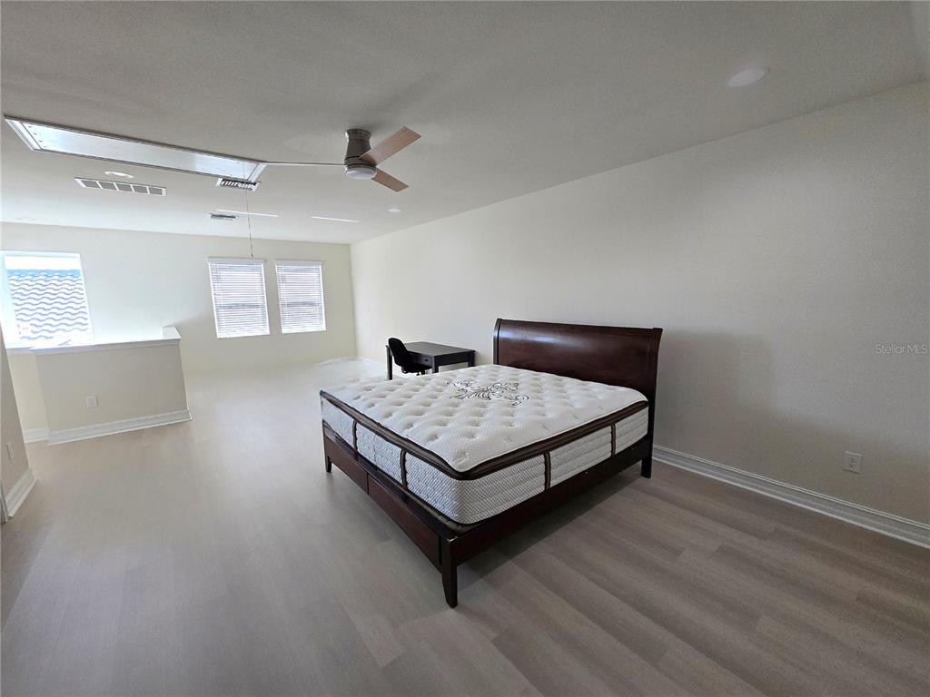 11925 Perennial Place Lakewood Ranch, FL 34211 - Photo 19 of 39 a bedroom with a bed and window