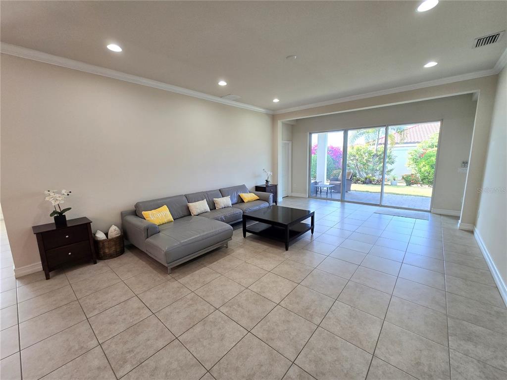 11925 Perennial Place Lakewood Ranch, FL 34211 - Photo 2 of 39 a living room with furniture and a flat screen tv