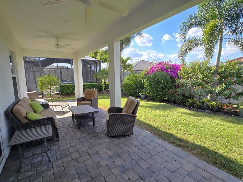 11925 Perennial Place Lakewood Ranch, FL 34211 - Photo 30 of 39 a living room with furniture and a garden
