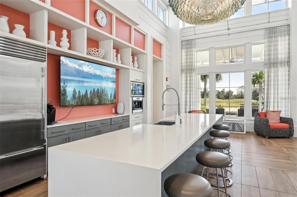 11925 Perennial Place Lakewood Ranch, FL 34211 - Photo 35 of 39 a kitchen with stainless steel appliances granite countertop a lot of counter space and living room