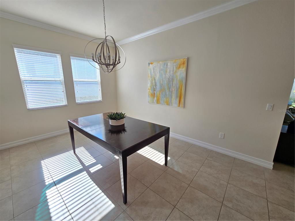 11925 Perennial Place Lakewood Ranch, FL 34211 - Photo 6 of 39 a view of a room with a table and chairs