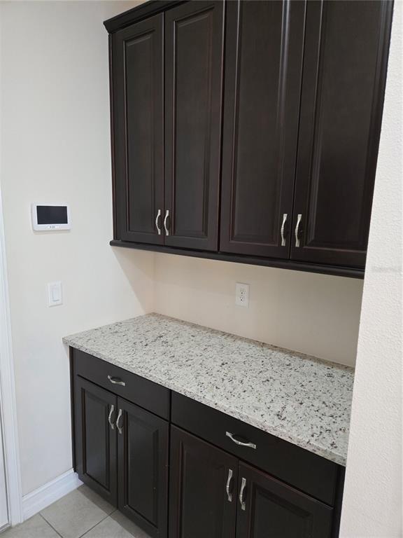 11925 Perennial Place Lakewood Ranch, FL 34211 - Photo 7 of 39 a sink with granite countertop wooden cabinets