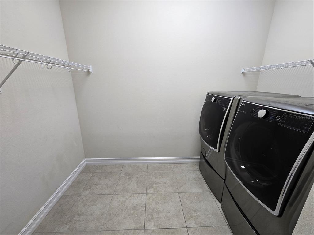 11925 Perennial Place Lakewood Ranch, FL 34211 - Photo 8 of 39 a utility room with dryer and washer