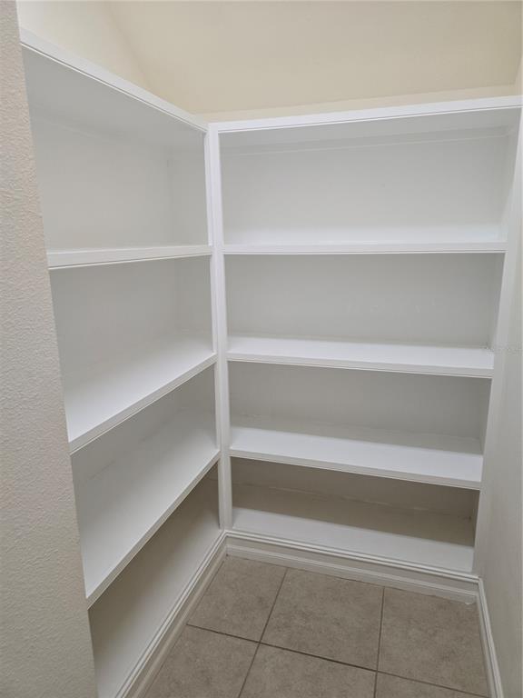 11925 Perennial Place Lakewood Ranch, FL 34211 - Photo 9 of 39 a view of walk in closet with empty racks