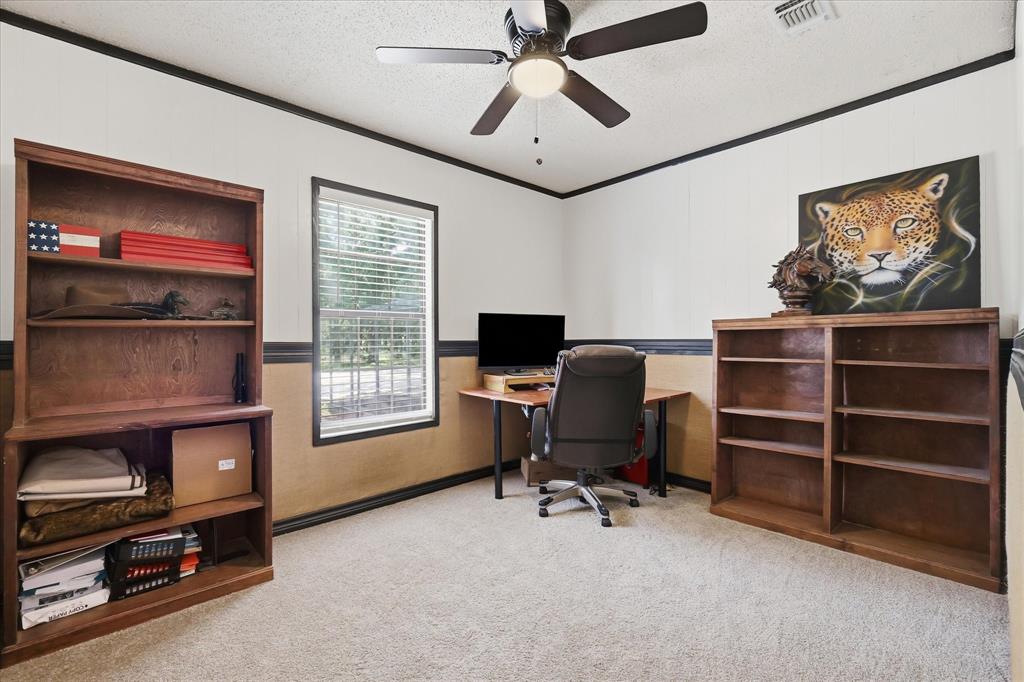 237 Brenda Lane Gainesville, TX 76240 - Photo 12 of 40 Carpeted room featuring a ceiling fan with light fixture, a window with horizontal blinds, and a two-tone wall treatment with dark trim