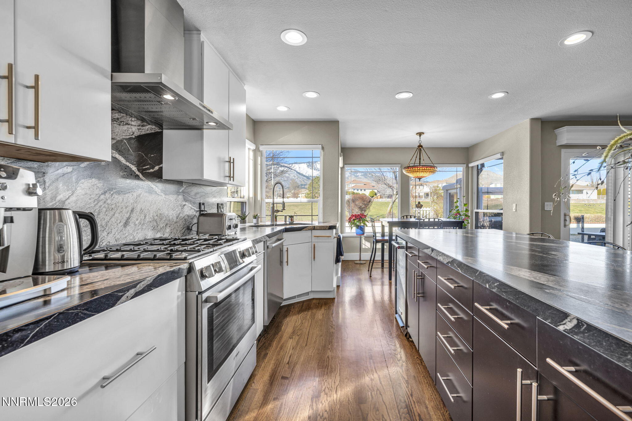 2296 Oak Ridge Drive Carson City, NV 89703 - Photo 17 of 71 a kitchen with stainless steel appliances granite countertop sink stove top oven and cabinets