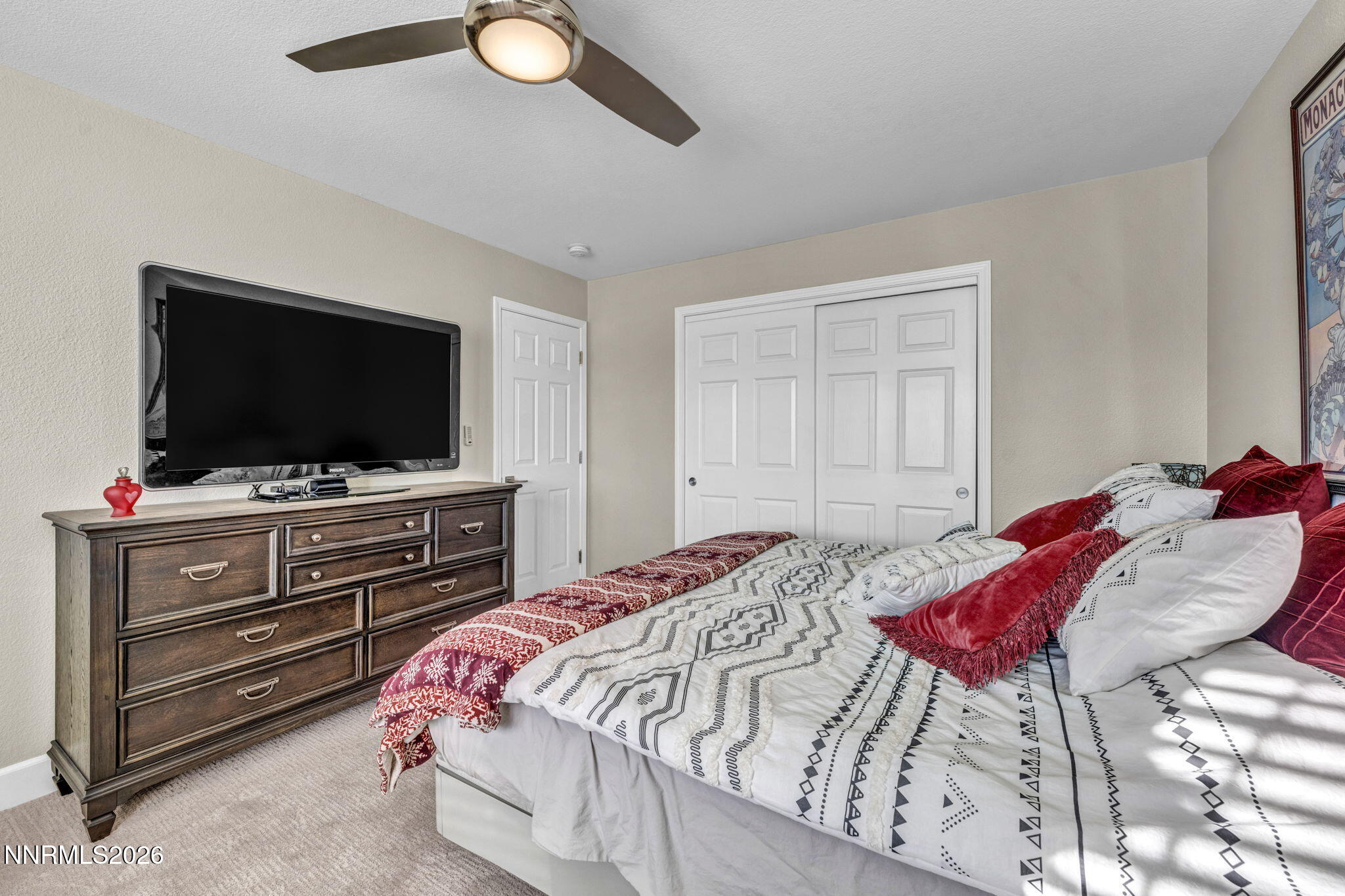 2296 Oak Ridge Drive Carson City, NV 89703 - Photo 44 of 71 a bedroom with a bed and a flat screen tv