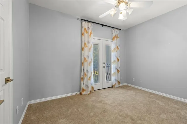 an empty room with wooden floor and hallway
