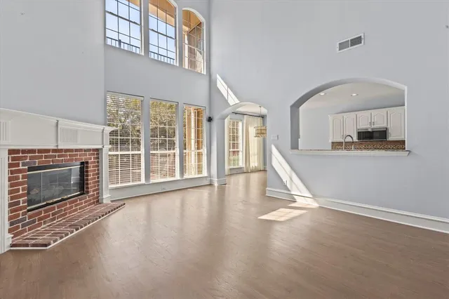 a view of a livingroom with wooden floor and a fireplace