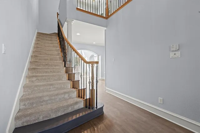 a view of entryway and hall with wooden floor