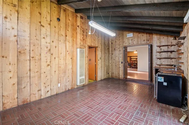 a view of a hallway with wooden floor and entryway