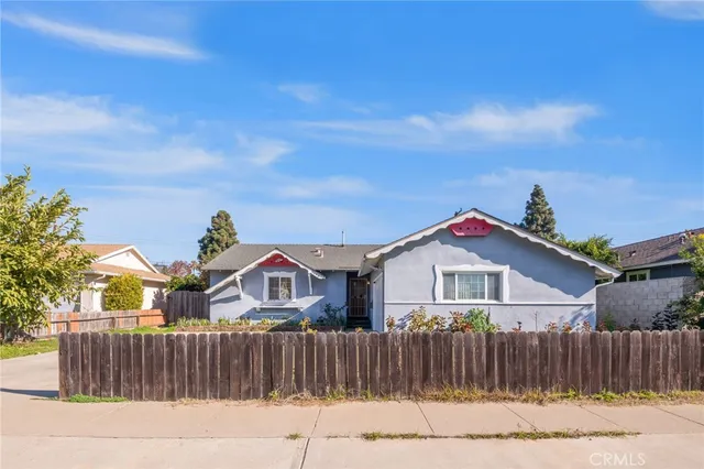 a view of a house with wooden fence