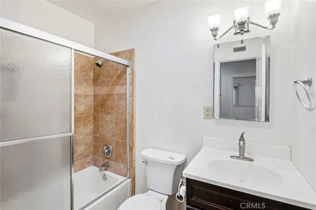 a bathroom with a sink mirror bathtub and toilet
