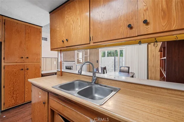 a kitchen with granite countertop a sink and cabinets