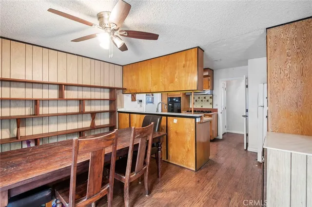 a view of a workspace with furniture and a book shelf