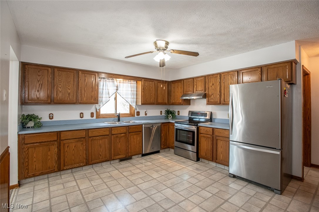 2624 Lester Road Medina, OH 44256 - Photo 13 of 50 Eat in Kitchen with Stainless Steel appliances range hood and vinyl flooring and 2 pantries
