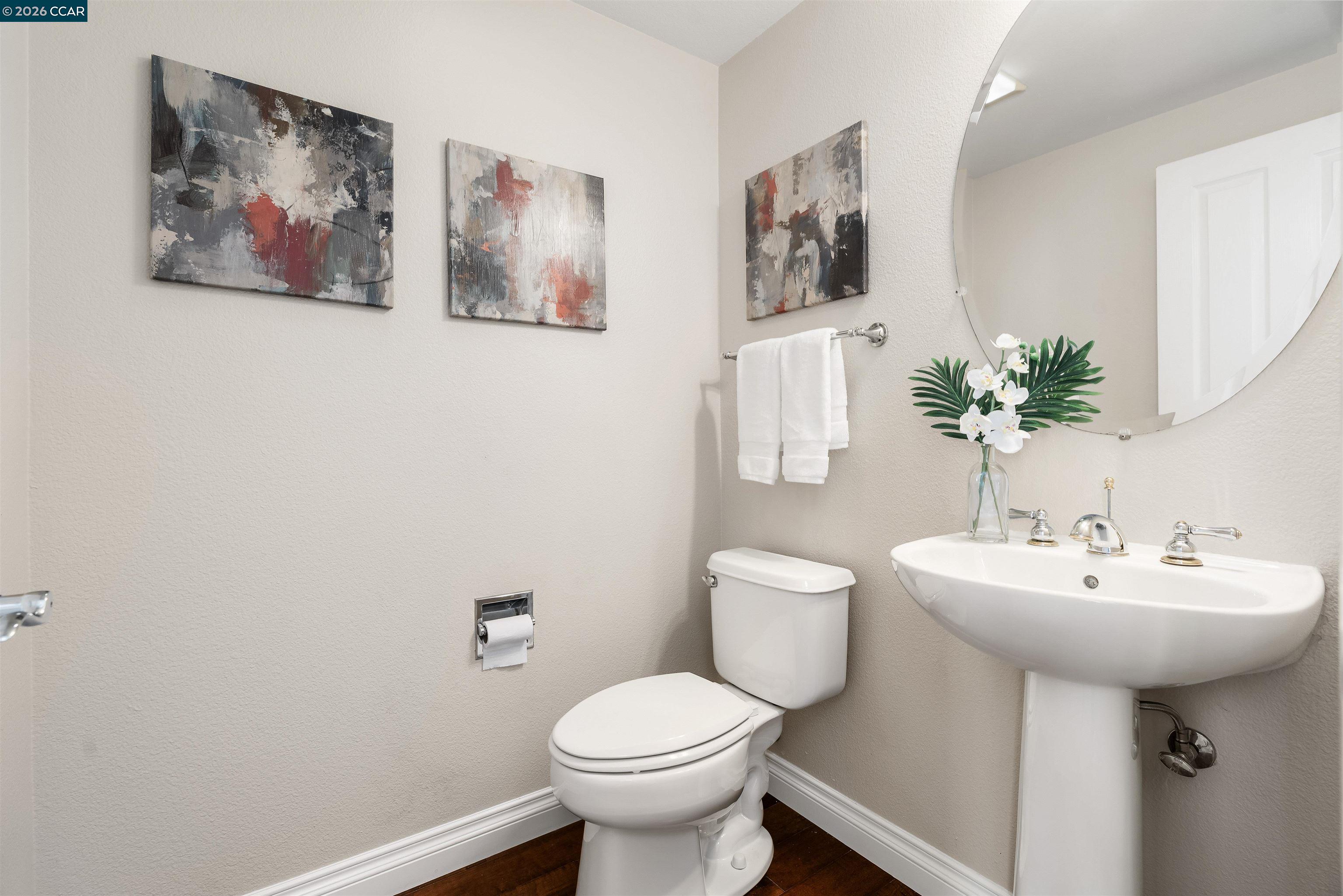 7151 Briza Loop San Ramon, CA 94582 - Photo 13 of 29 a bathroom with a toilet sink and mirror
