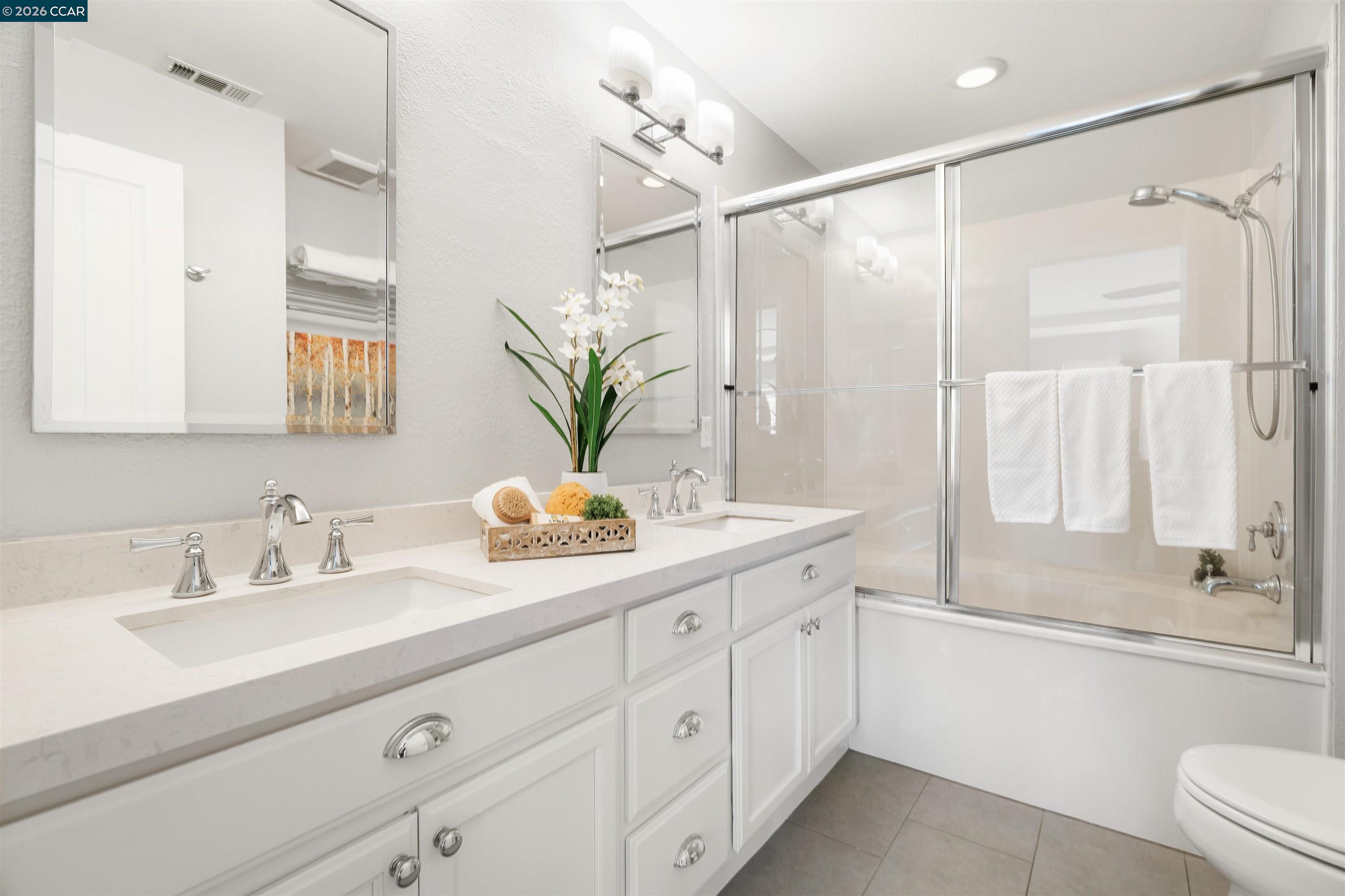 7151 Briza Loop San Ramon, CA 94582 - Photo 17 of 29 a bathroom with a double vanity sink and a mirror