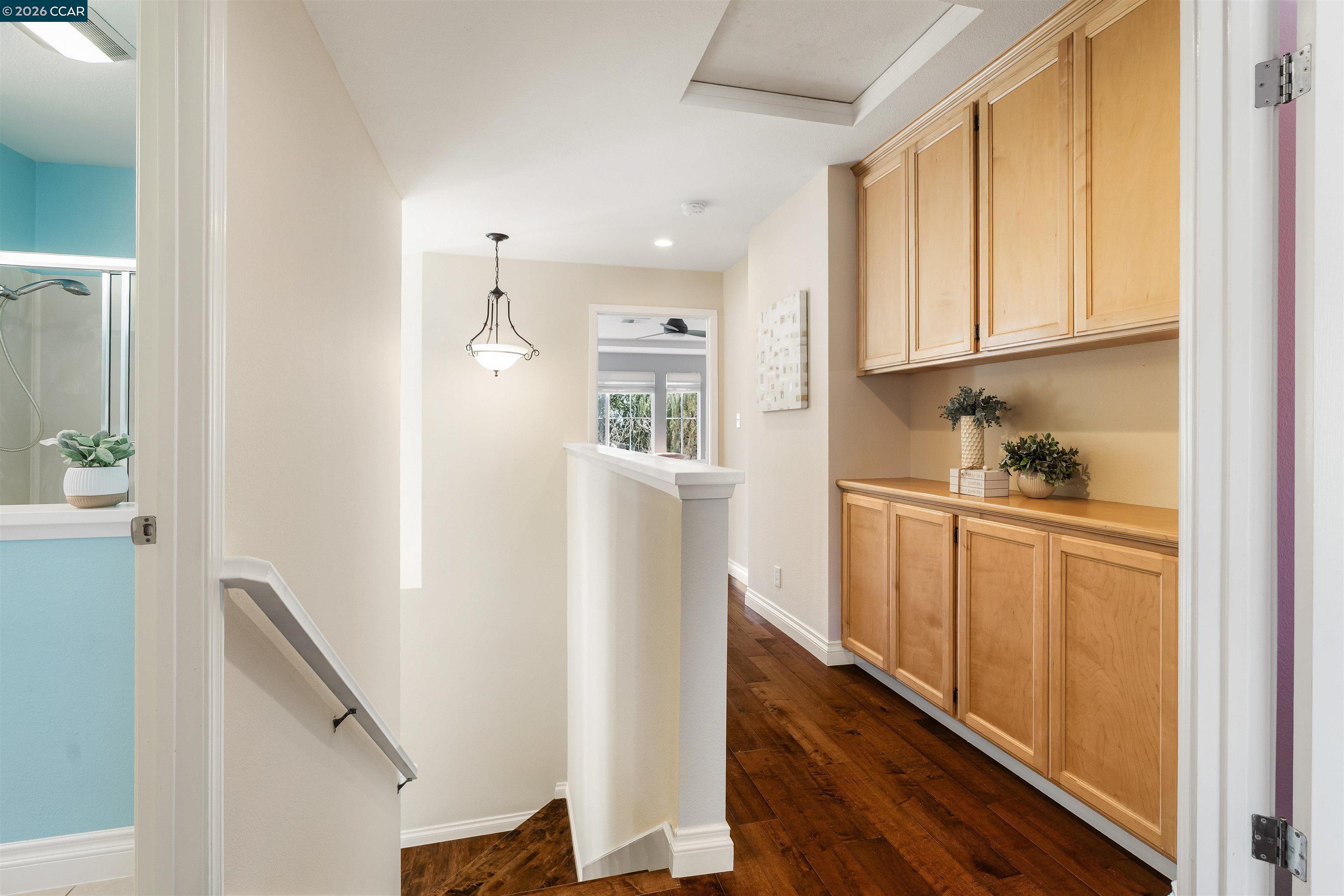 7151 Briza Loop San Ramon, CA 94582 - Photo 18 of 29 a kitchen with white cabinets and wooden floor